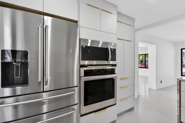 a kitchen with stainless steel appliances and refrigerator