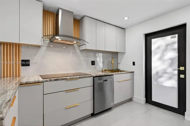 a kitchen with stainless steel appliances granite countertop a sink a stove and a refrigerator