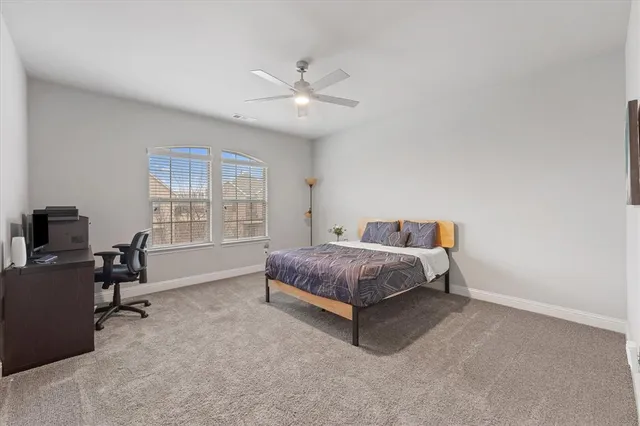 a spacious bedroom with a bed and a window