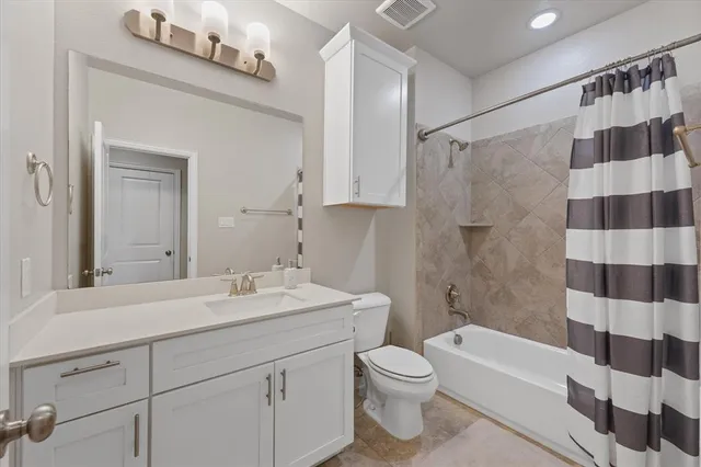 a bathroom with a sink a toilet a mirror and shower