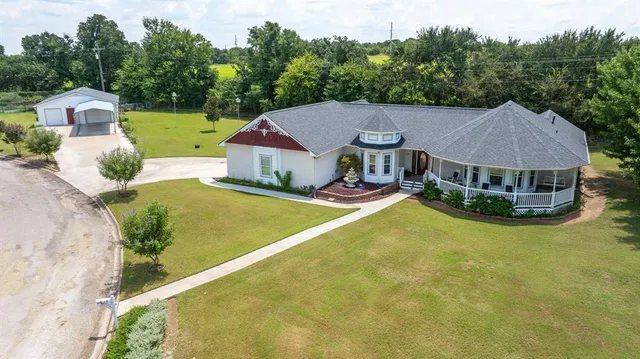 a view of a house with pool and a yard