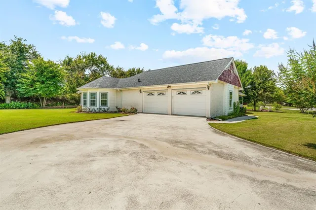 a view of an house with backyard space and balcony