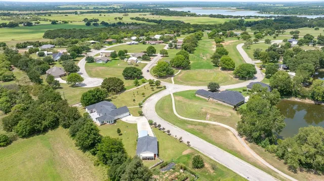 an aerial view of residential houses with outdoor space and swimming pool