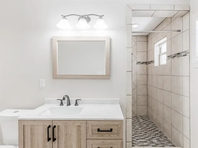 a bathroom with a sink a vanity and a mirror