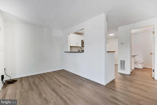a view of a big room with wooden floor and bathroom