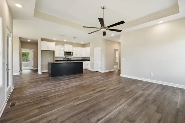 a large kitchen with stainless steel appliances granite countertop a stove a sink and a refrigerator