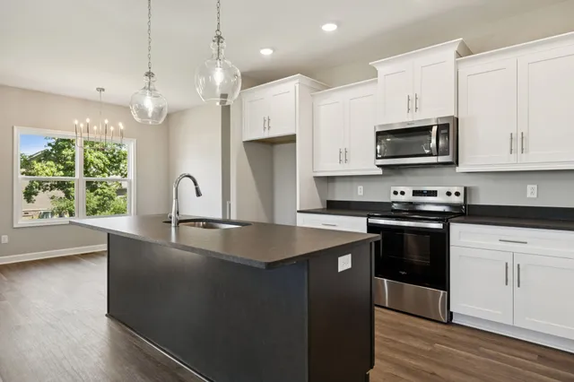 a view of a kitchen with wooden floor and a sink