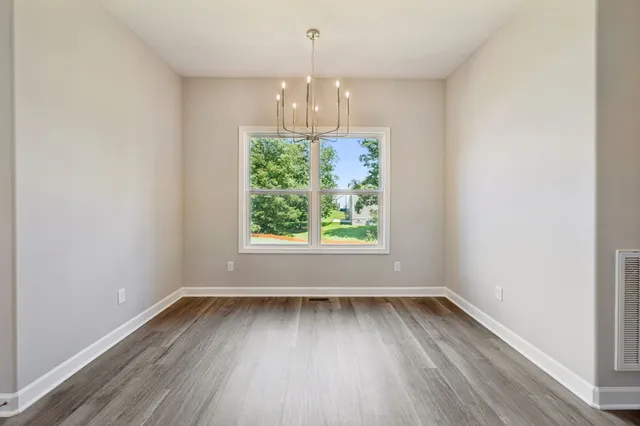 an empty room with window and closet