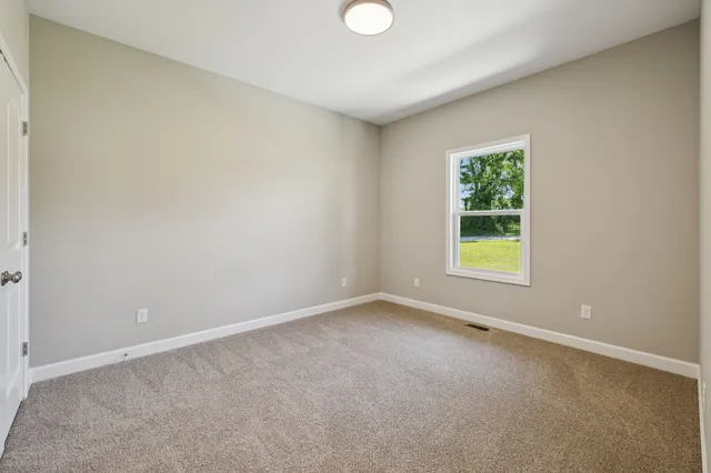 an empty room with windows and entrance