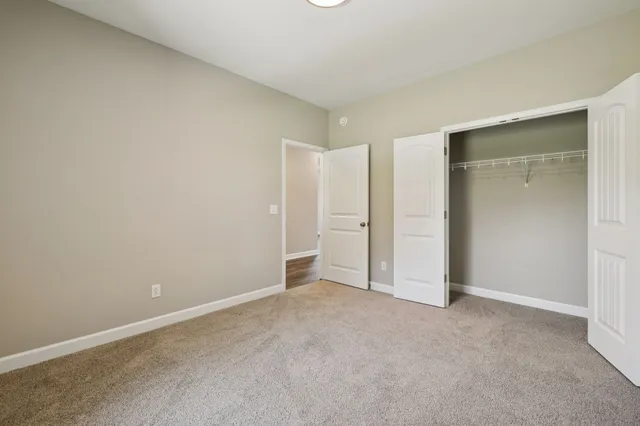 a bathroom with a double vanity sink a toilet a mirror and bathtub