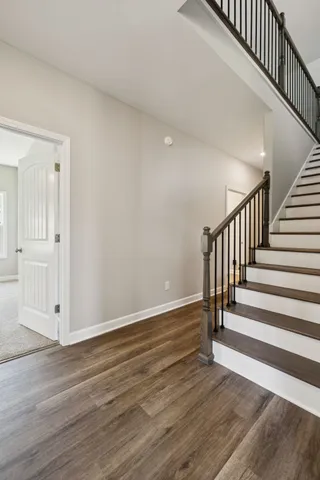 an empty room with a ceiling fan and window