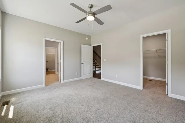 a view of a livingroom with a ceiling fan and window