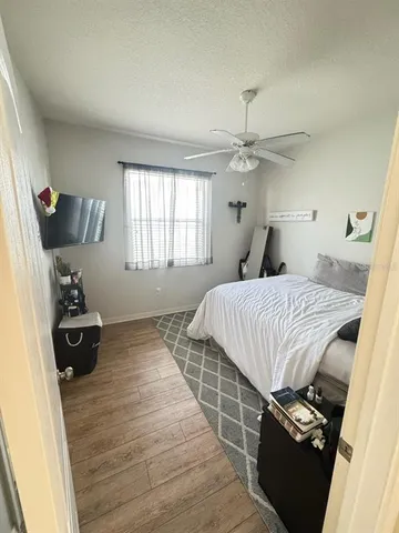 a bedroom with a bed and a mirror on the dresser