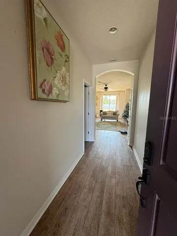 a view of a hallway view with wooden floor and staircase