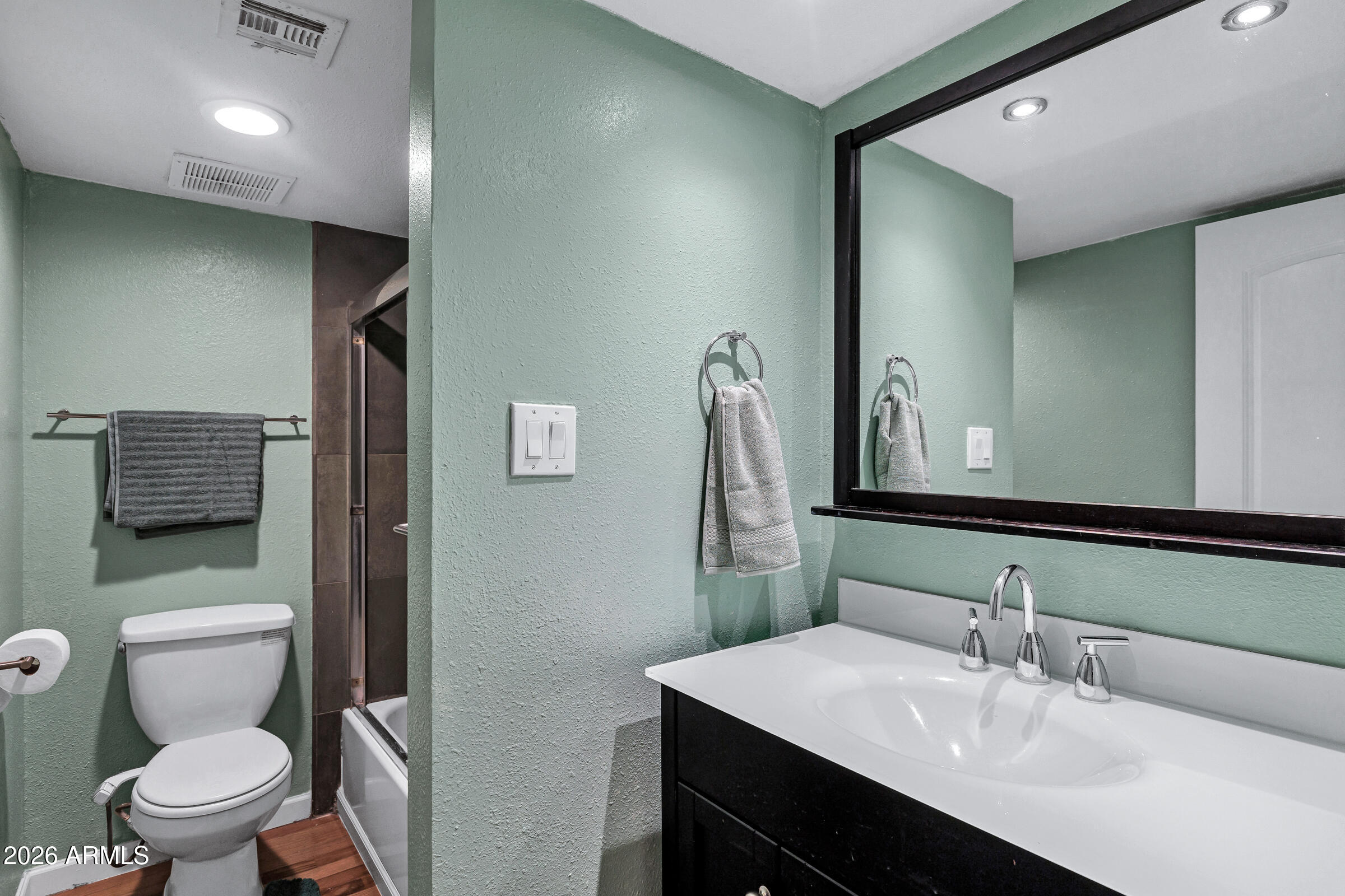 4410 North Longview Avenue, Unit 119 Phoenix, AZ 85014 - Photo 11 of 22 a bathroom with a sink a toilet and shower