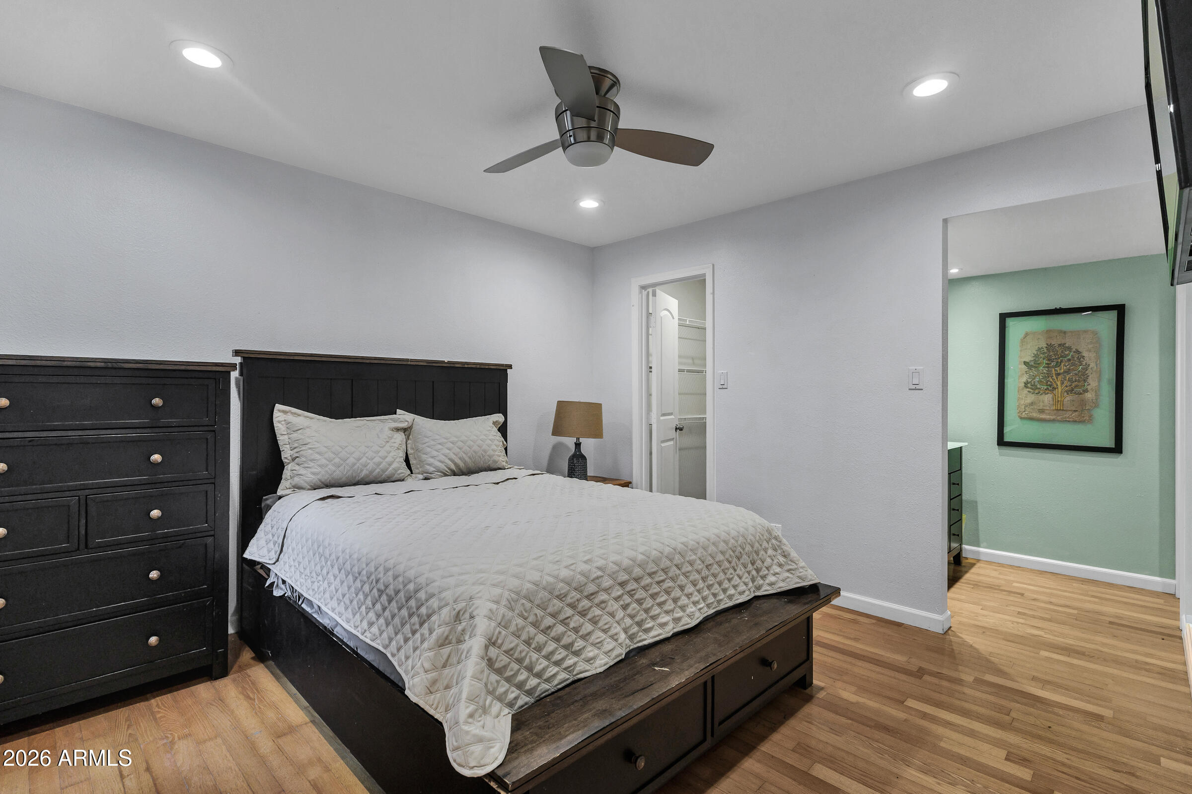 4410 North Longview Avenue, Unit 119 Phoenix, AZ 85014 - Photo 13 of 22 a bedroom with a bed and a chandelier