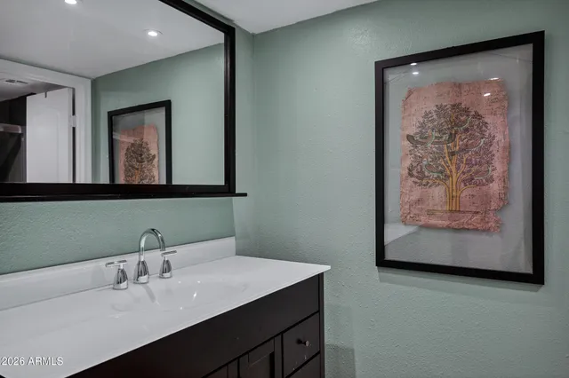 a bathroom with a sink and a mirror