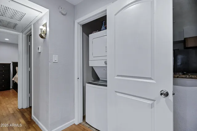 a view of a hallway with wooden floor and closet