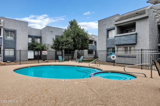 a view of a house with swimming pool and sitting area