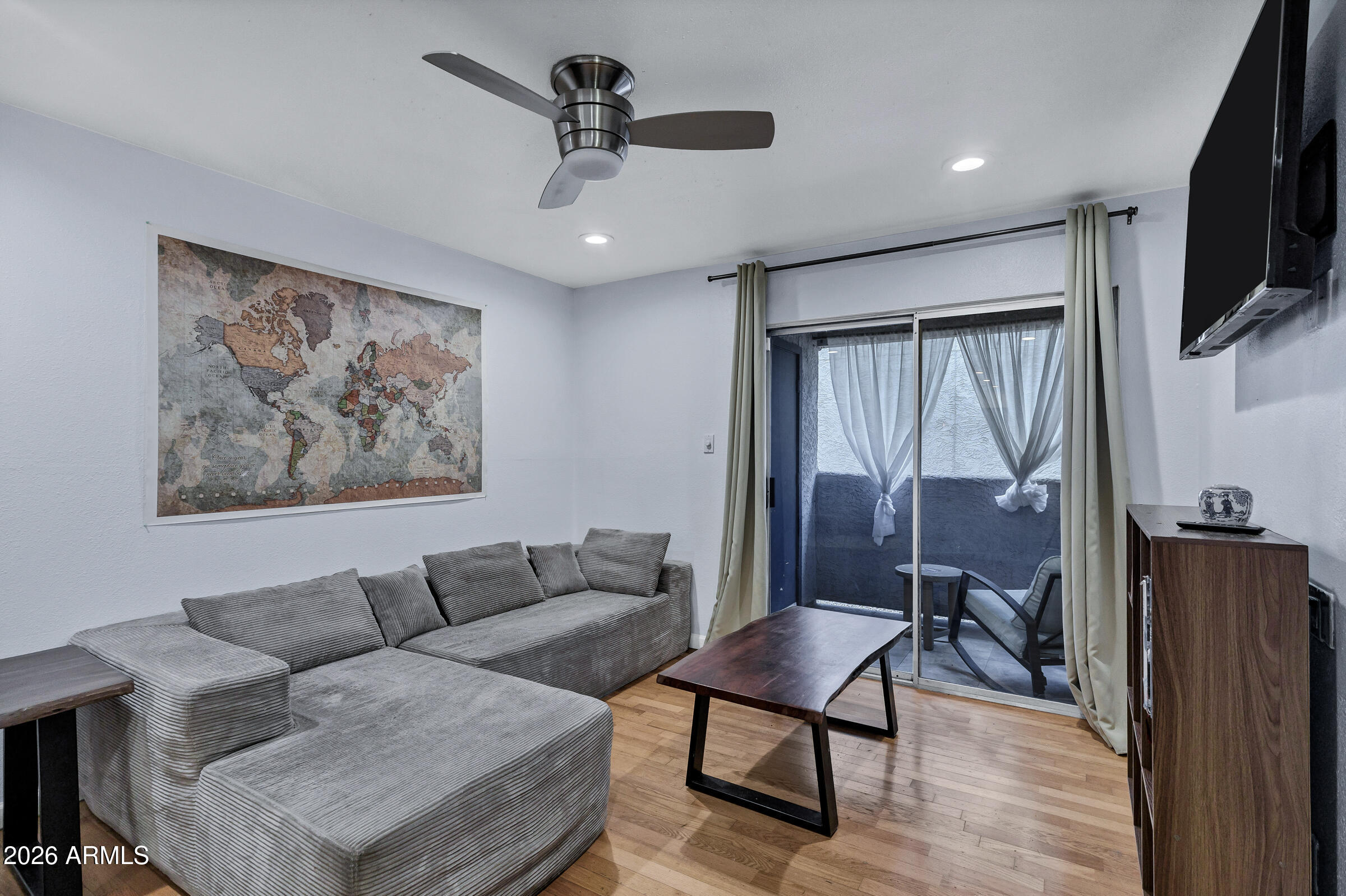 4410 North Longview Avenue, Unit 119 Phoenix, AZ 85014 - Photo 5 of 22 a living room with furniture a ceiling fan and a flat screen tv