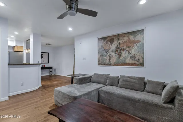 a living room with furniture and a wooden floor