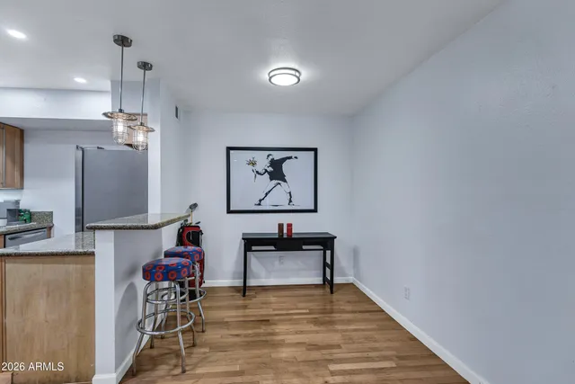a view of a workspace with furniture and a chandelier
