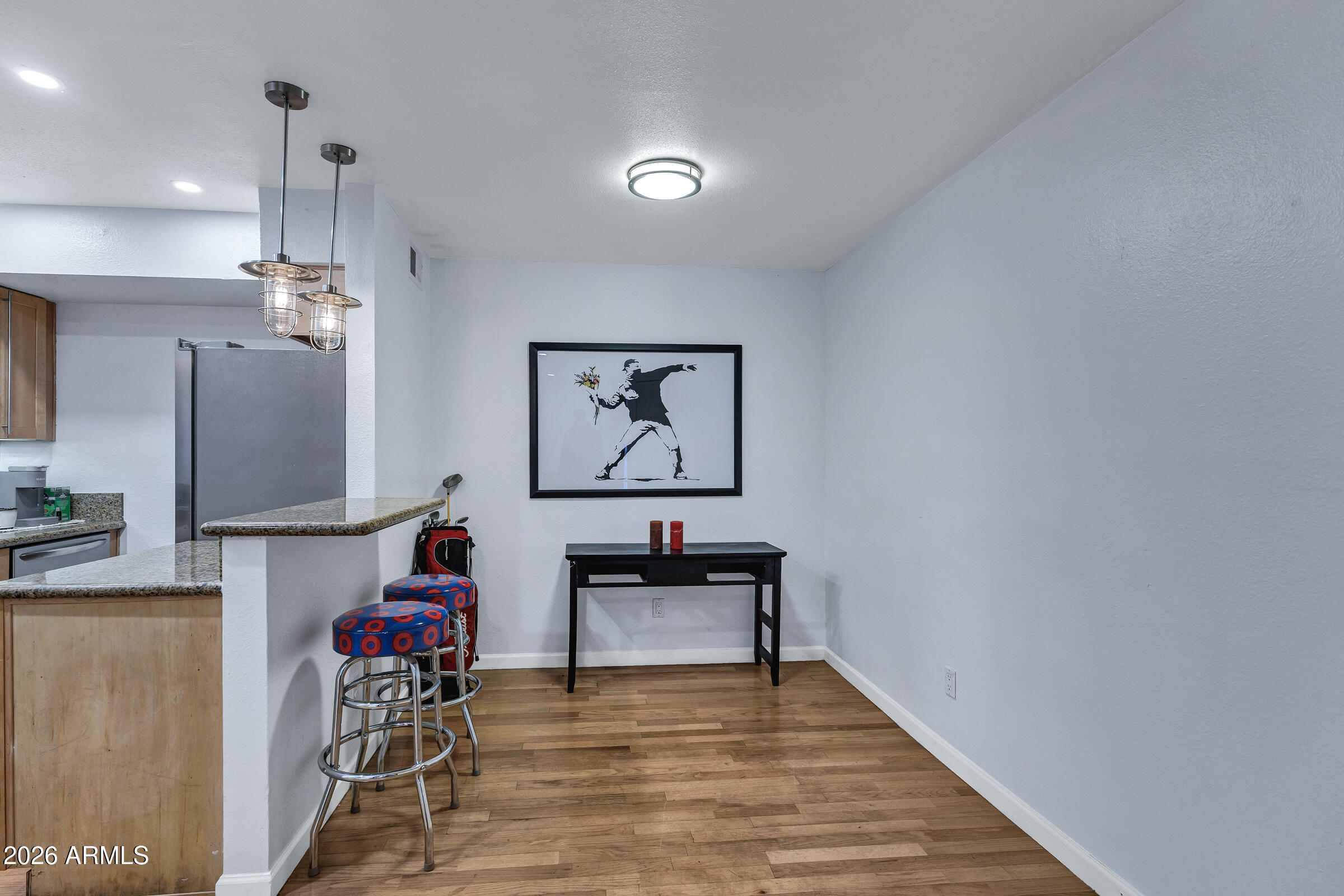 4410 North Longview Avenue, Unit 119 Phoenix, AZ 85014 - Photo 7 of 22 a view of a workspace with furniture and a chandelier