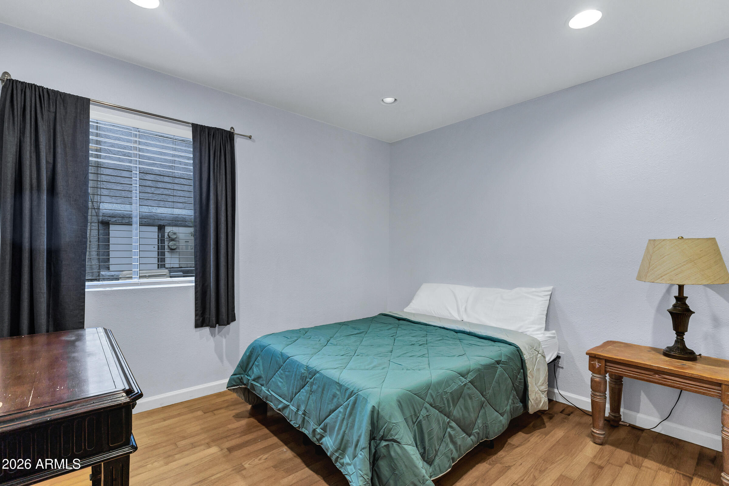 4410 North Longview Avenue, Unit 119 Phoenix, AZ 85014 - Photo 10 of 22 a bedroom with a bed and a window