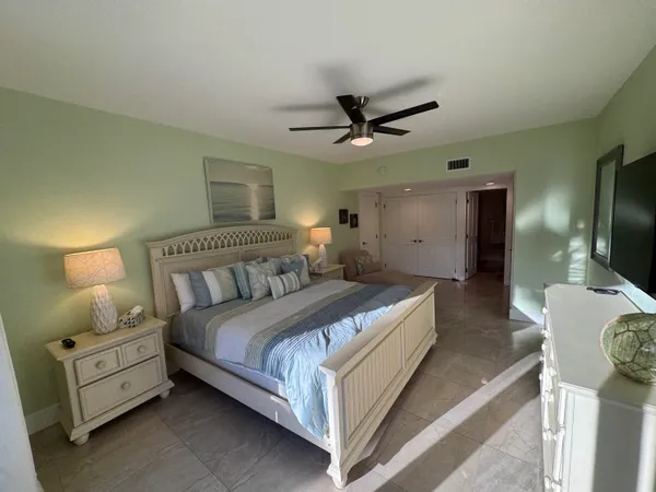a bedroom with bed and a flat screen tv