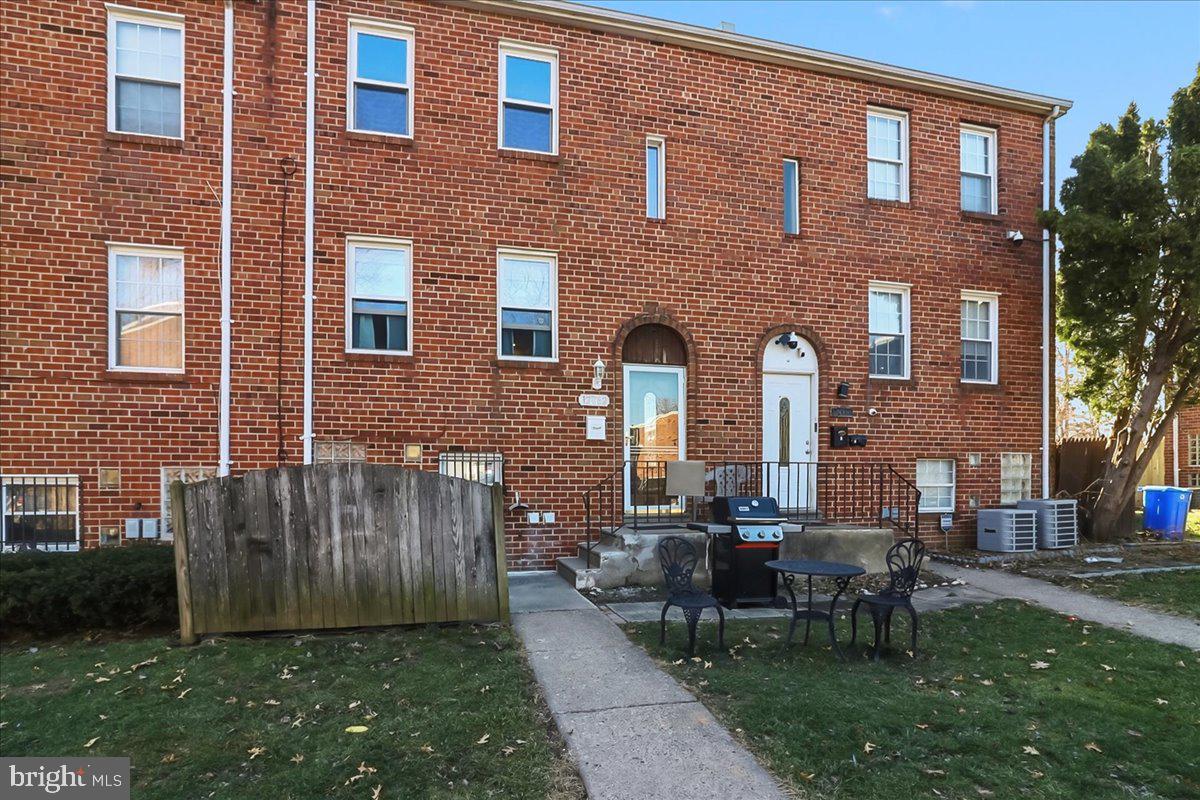 a front view of a house with garden and chairs