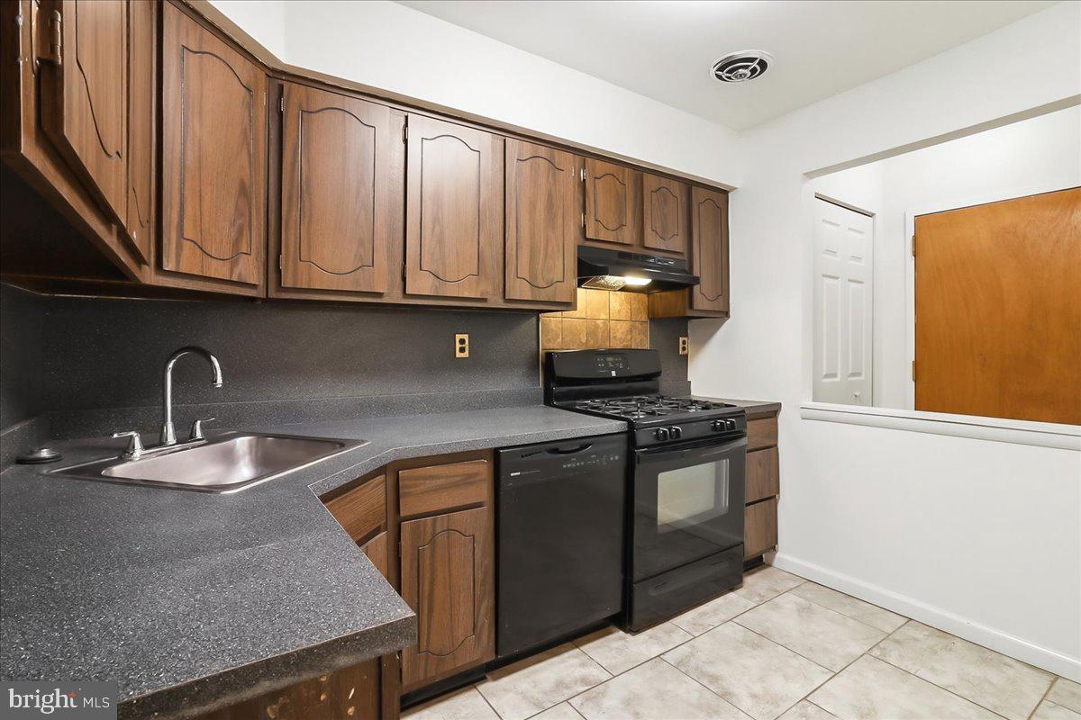 12062 Abby Road Philadelphia, PA 19154 - Photo 19 of 28 a kitchen with stainless steel appliances granite countertop a sink stove and cabinets