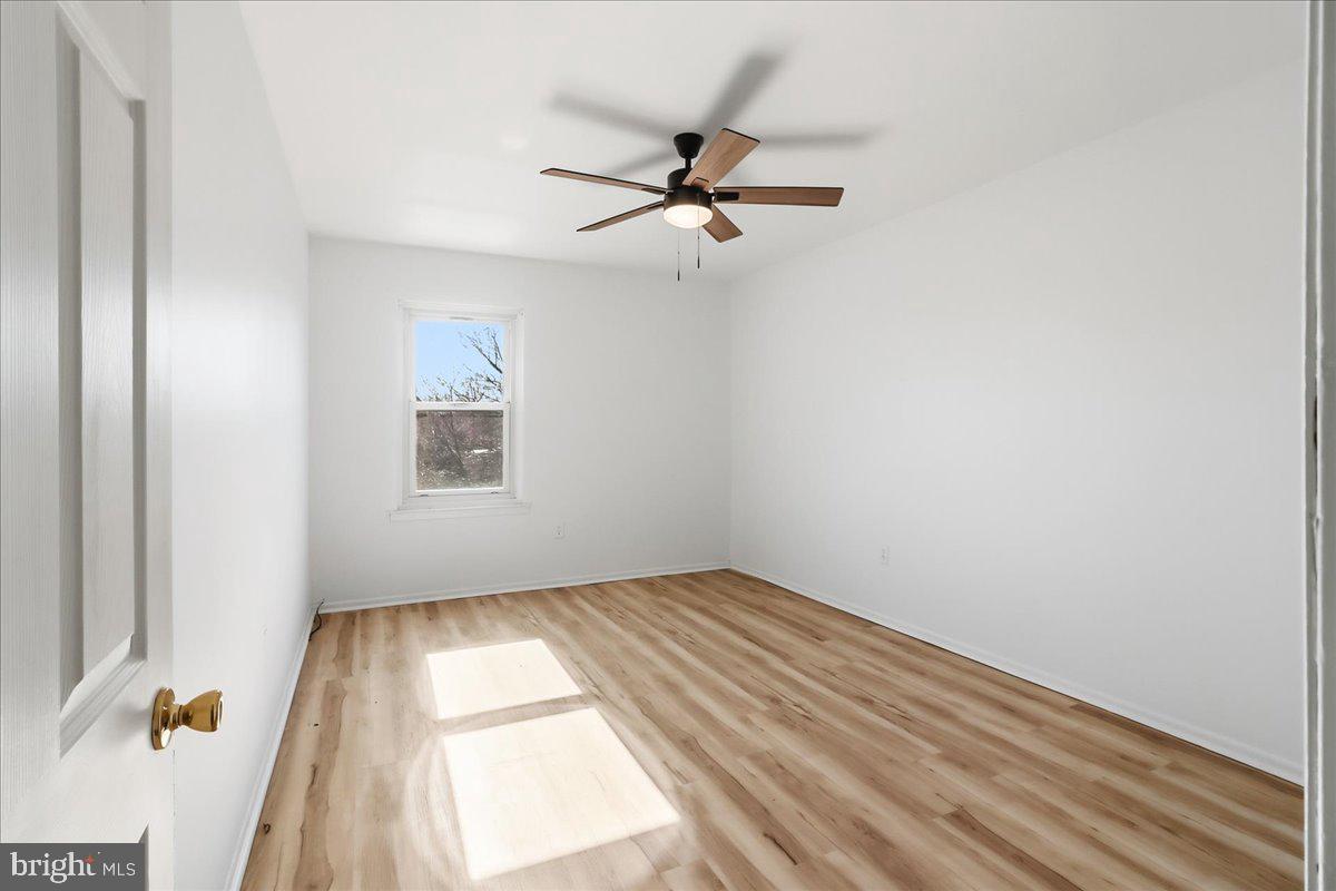 12062 Abby Road Philadelphia, PA 19154 - Photo 24 of 28 an empty room with a window and a ceiling fan