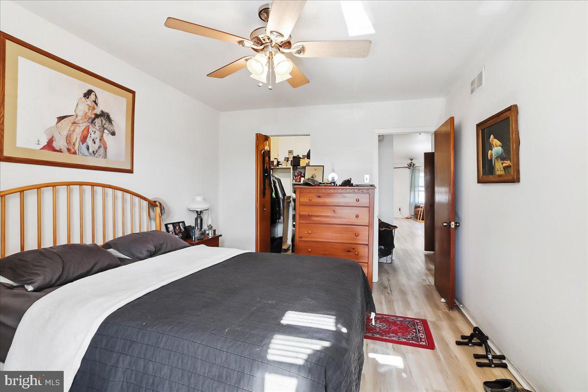 12062 Abby Road Philadelphia, PA 19154 - Photo 8 of 28 a bedroom with a bed and a chandelier