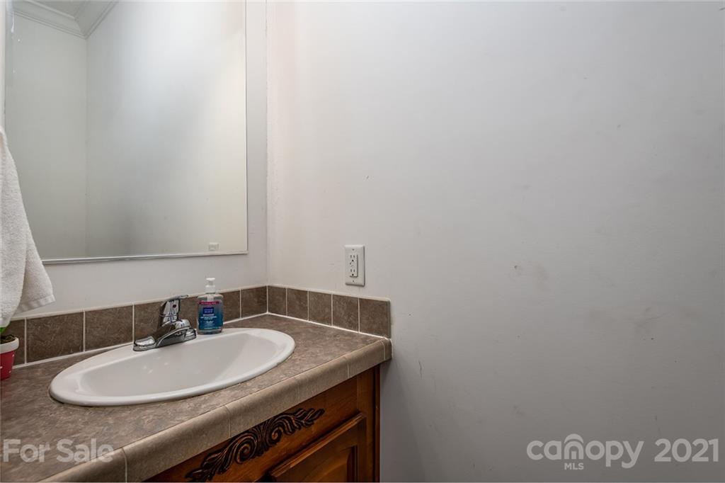 4478 Hickory Nut Ridge Road Hudson, NC 28638 - Photo 29 of 29 a bathroom with a sink and a mirror