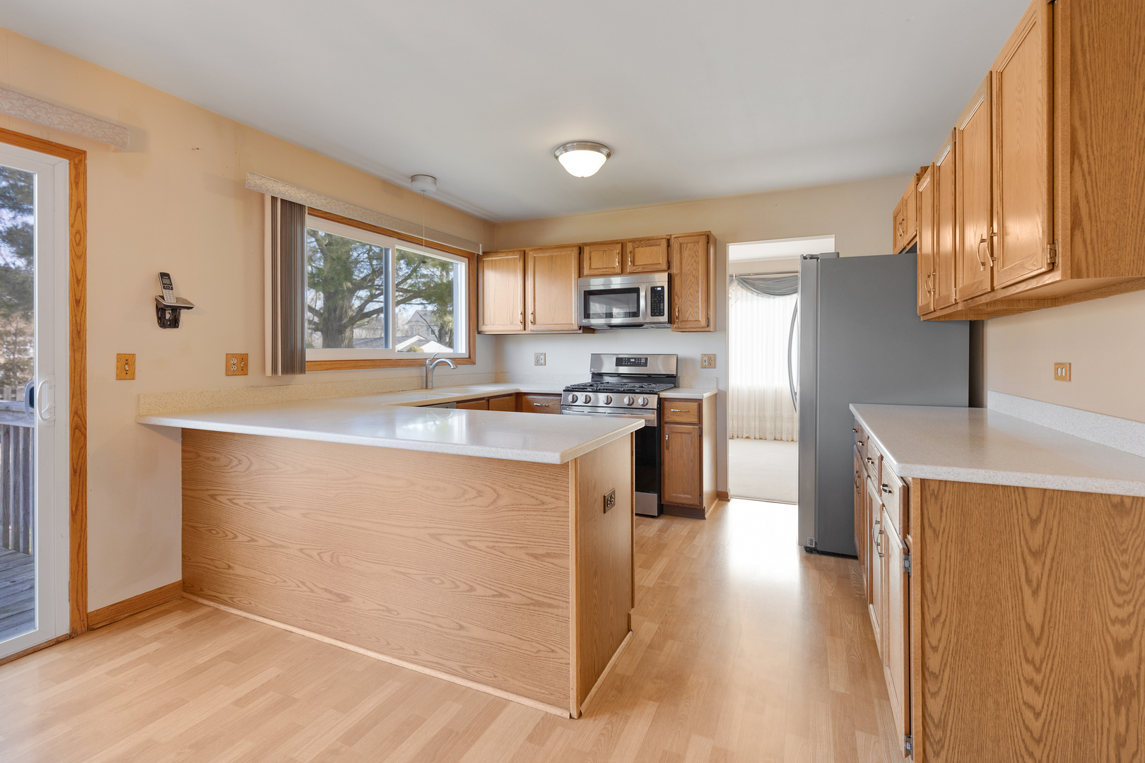 1950 Tanglewood Drive Algonquin, IL 60102 - Photo 2 of 34 a kitchen with kitchen island a counter top space a sink a refrigerator and a window