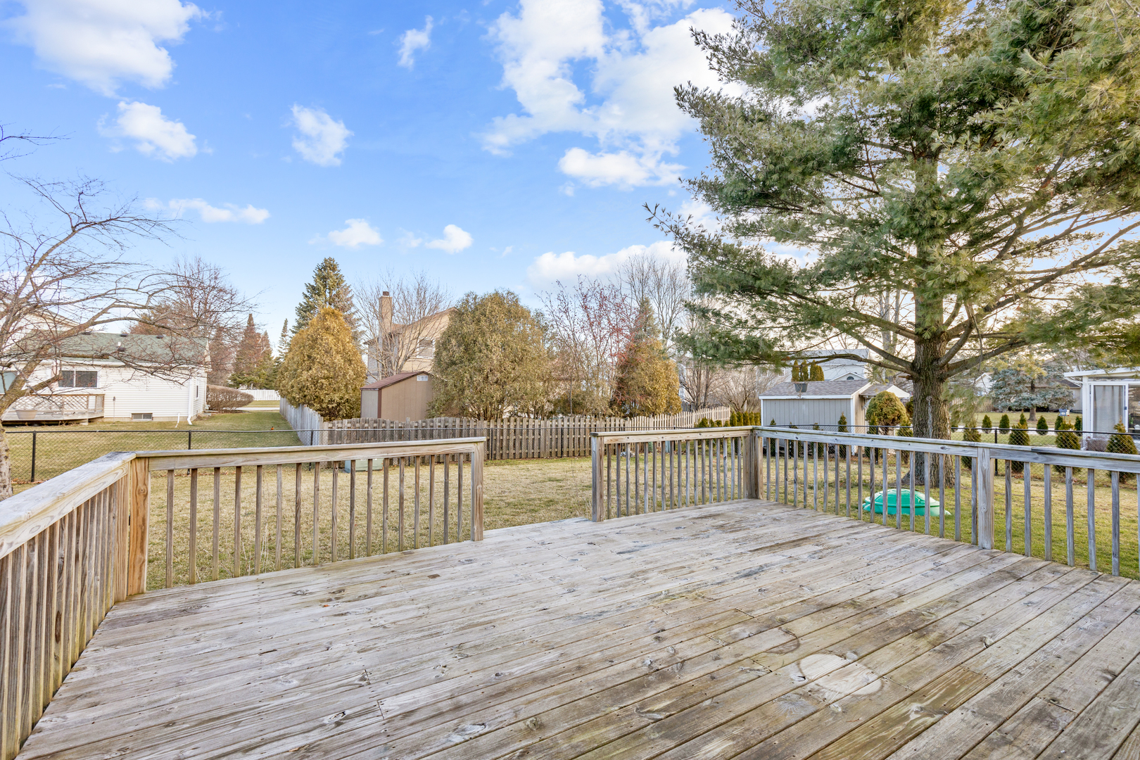 1950 Tanglewood Drive Algonquin, IL 60102 - Photo 24 of 34 a view of a house with wooden deck next to a lake