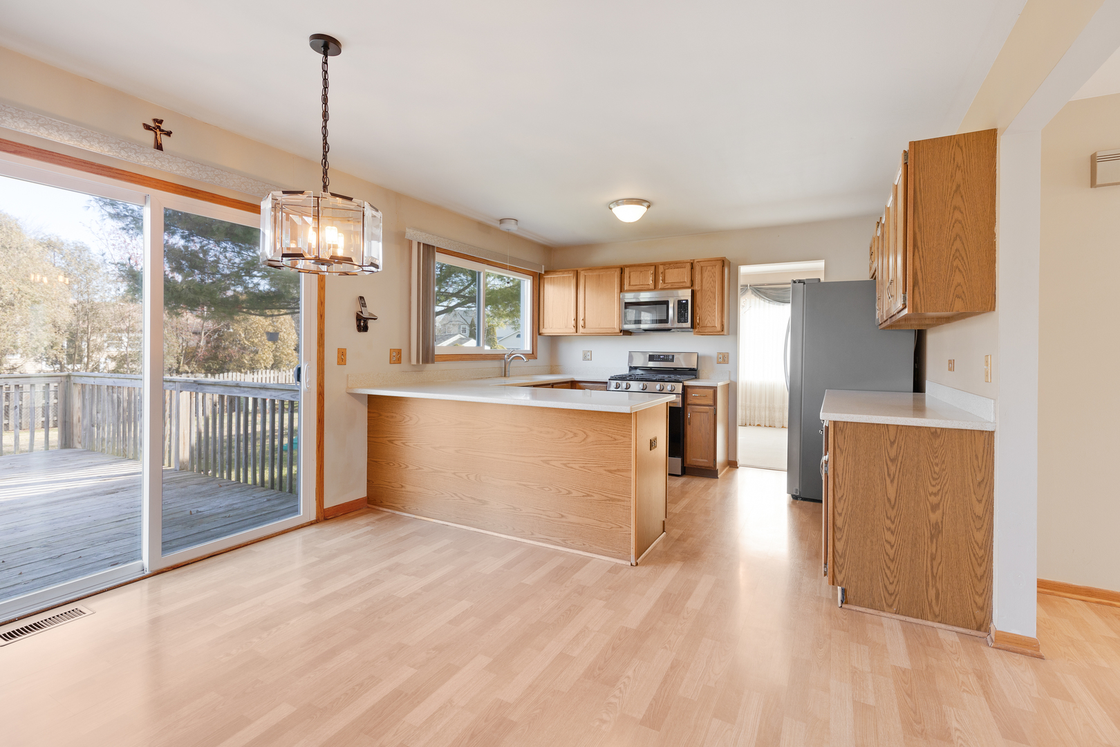 1950 Tanglewood Drive Algonquin, IL 60102 - Photo 4 of 34 a view of kitchen with stainless steel appliances granite countertop a stove top oven a refrigerator a sink and dishwasher with wooden floor