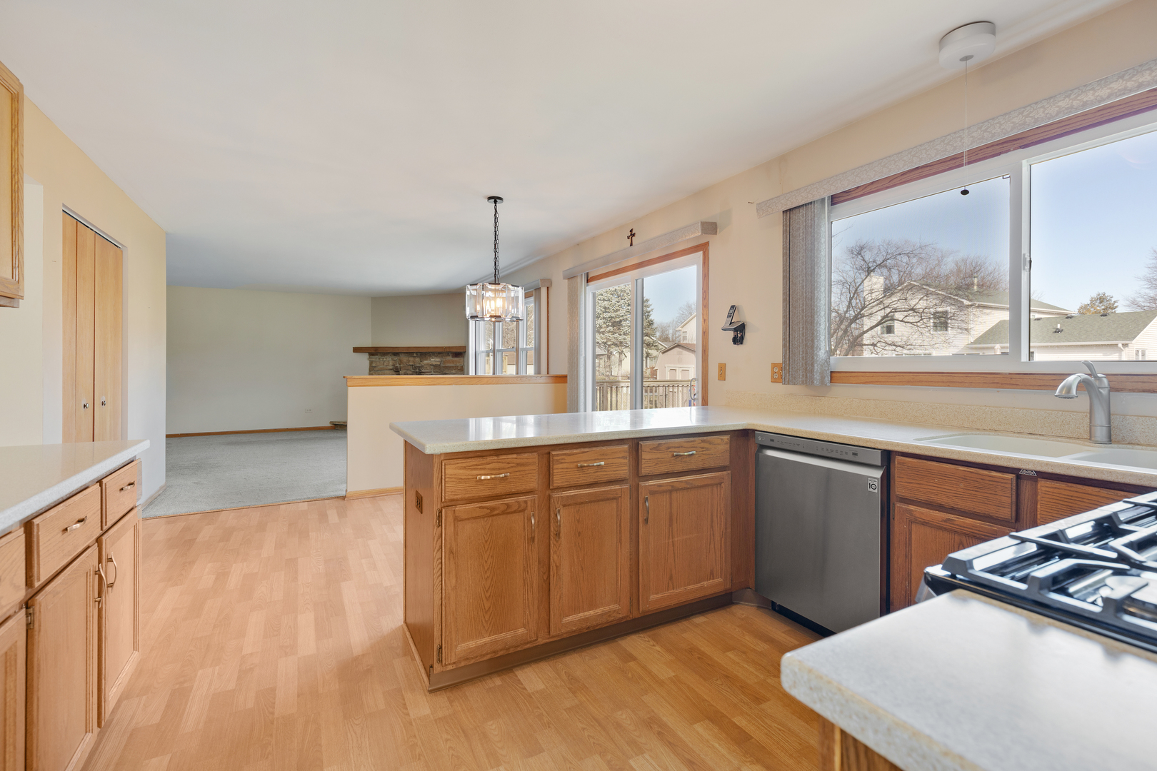 1950 Tanglewood Drive Algonquin, IL 60102 - Photo 6 of 34 a kitchen with stainless steel appliances granite countertop a stove a sink dishwasher and a refrigerator with wooden floor