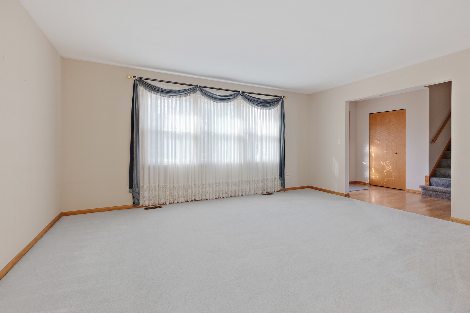 1950 Tanglewood Drive Algonquin, IL 60102 - Photo 7 of 34 a view of an empty room with wooden floor and a window
