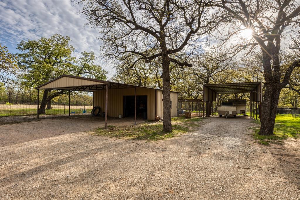 243 County Road 3851 Poolville, TX 76487 - Photo 30 of 34 a house with trees in front of it