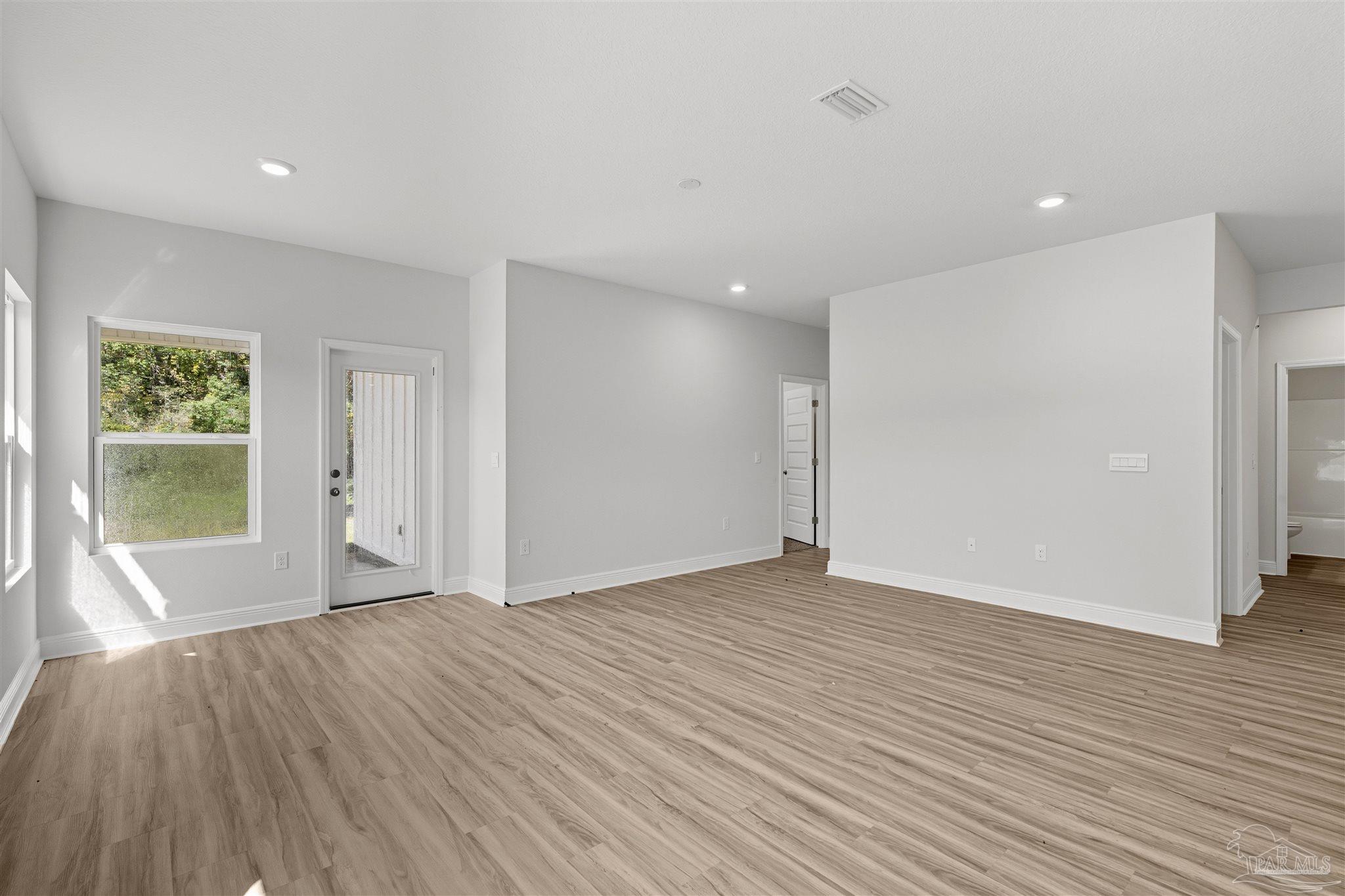 3460 Crossvine Road Cantonment, FL 32533 - Photo 26 of 41 a view of an empty room with wooden floor and a window