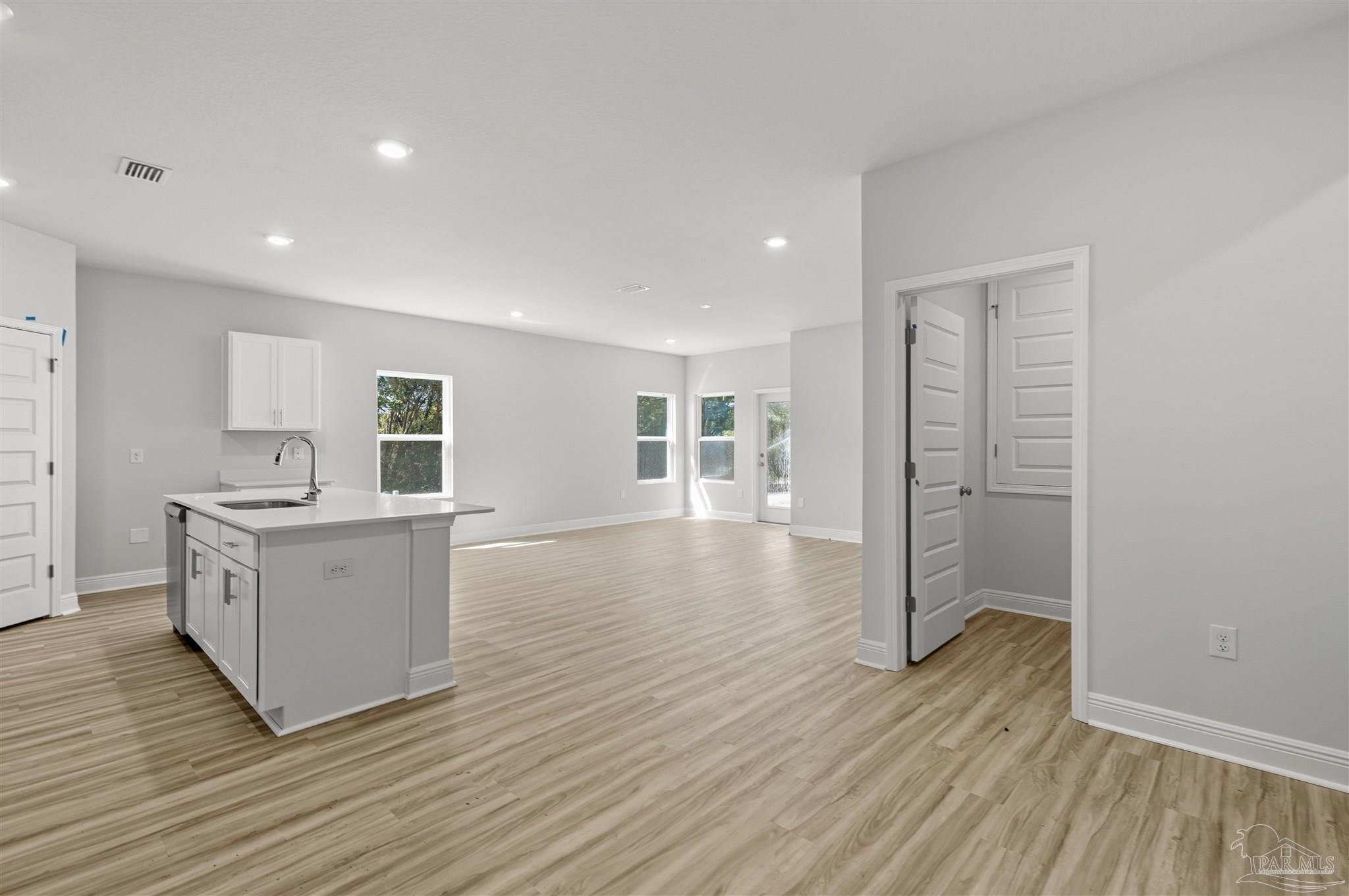 3460 Crossvine Road Cantonment, FL 32533 - Photo 31 of 41 a view of a kitchen with wooden floor and electronic appliances