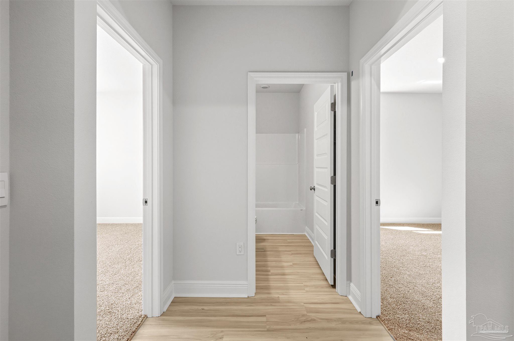 3460 Crossvine Road Cantonment, FL 32533 - Photo 6 of 41 a view of a hallway with wooden floor