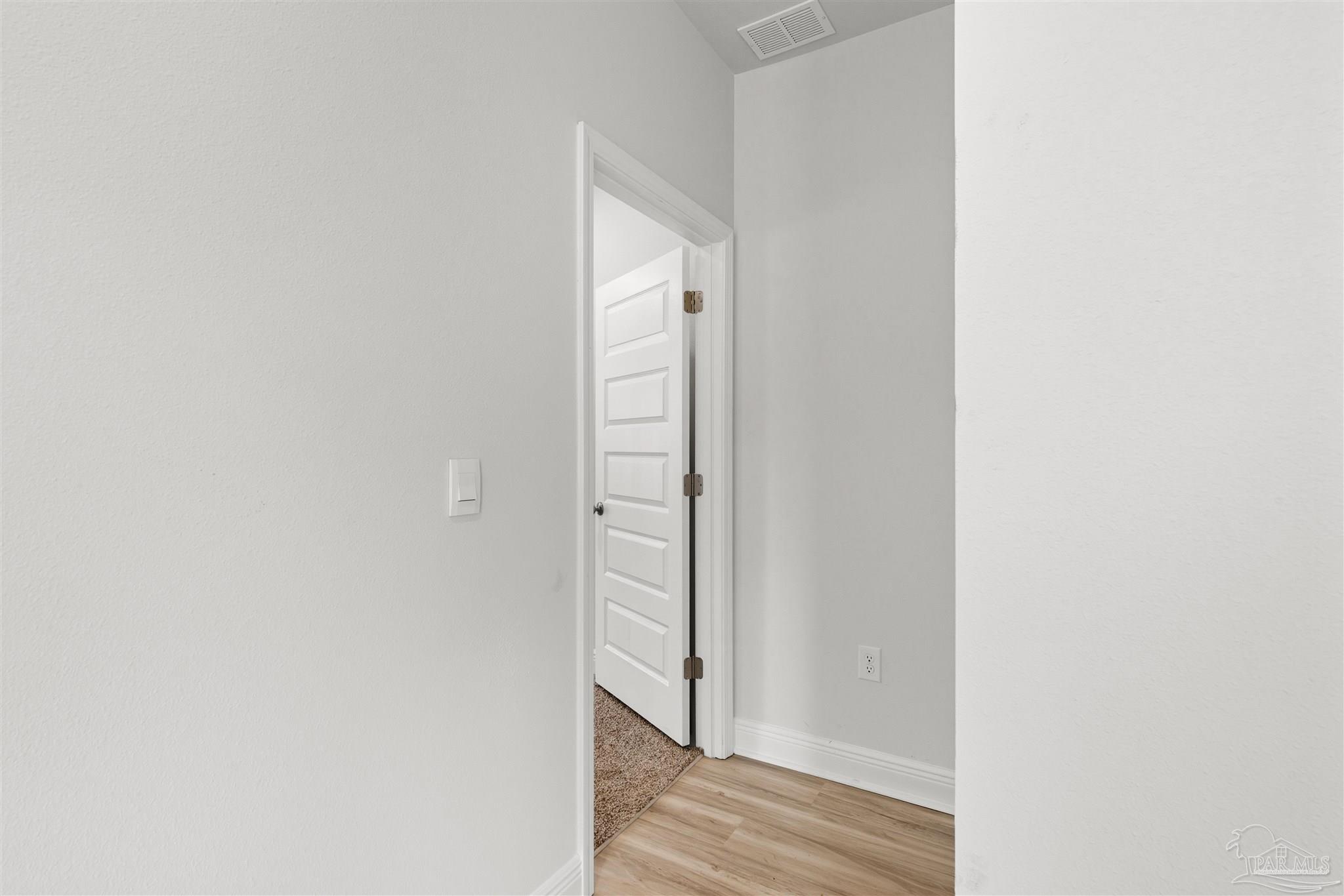 3460 Crossvine Road Cantonment, FL 32533 - Photo 9 of 41 a view of a hallway with wooden floor