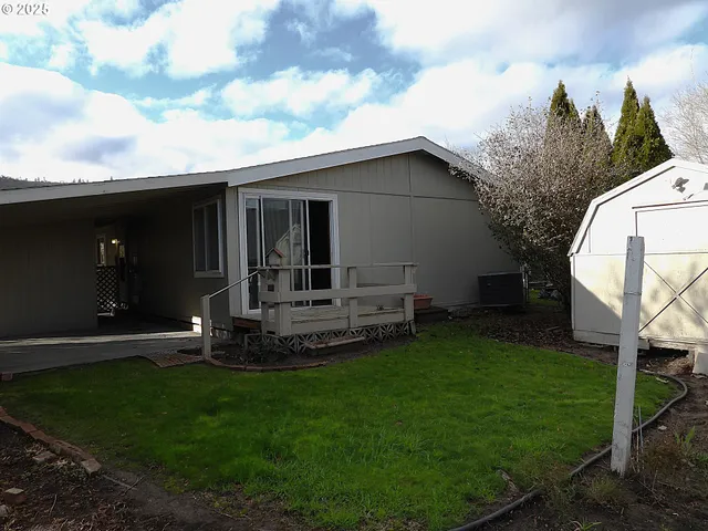 a view of a house with backyard sitting area and garden