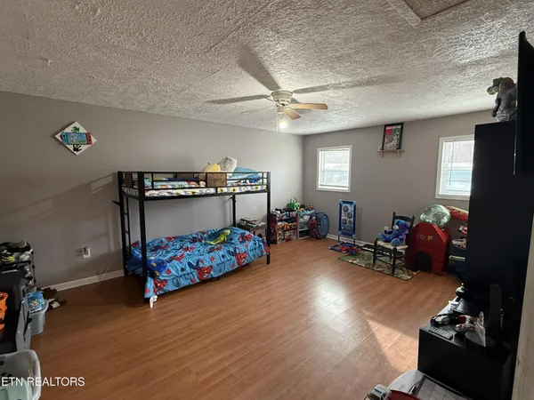 a bedroom with furniture and a wooden floor