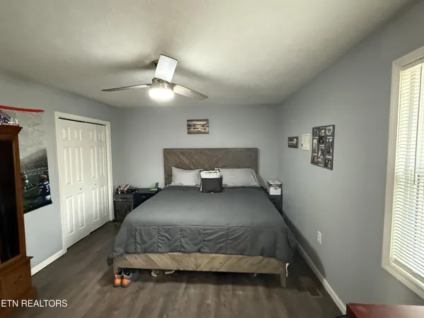 a bedroom with a bed and window