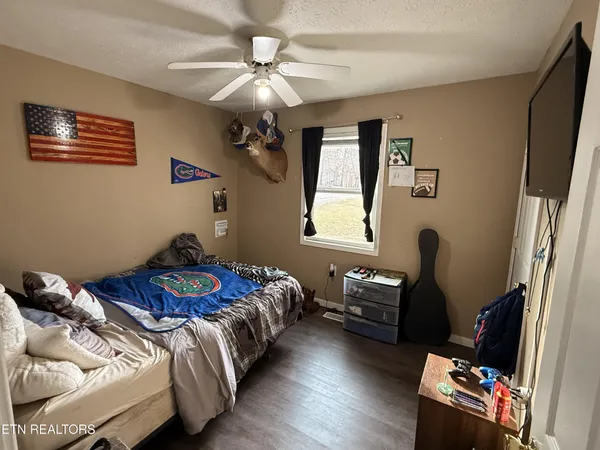 a bedroom with a bed and a chandelier