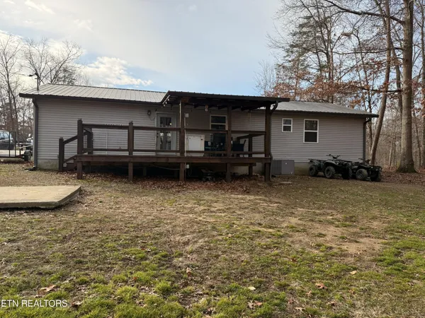 a view of a house with a yard and wooden floor