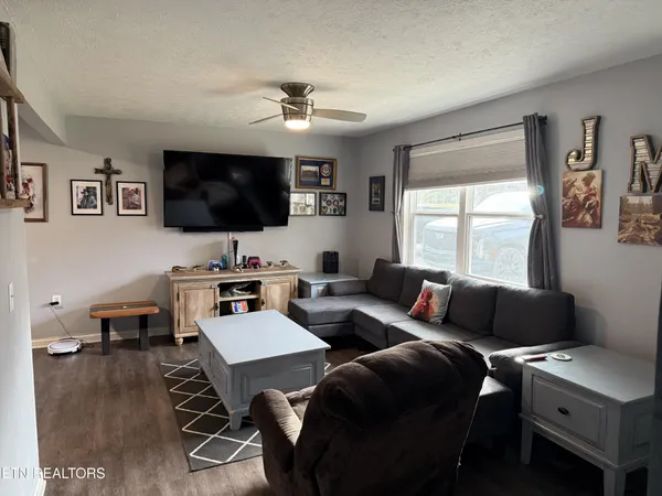 a living room with furniture and a flat screen tv